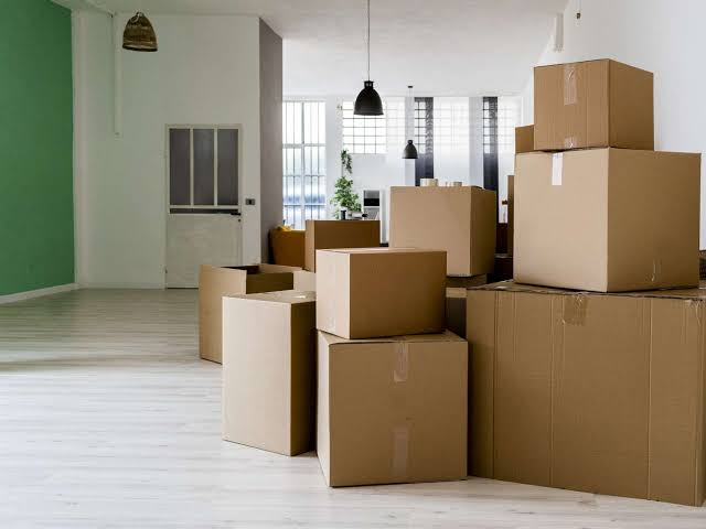 MovePlus movers carefully handling packed household boxes