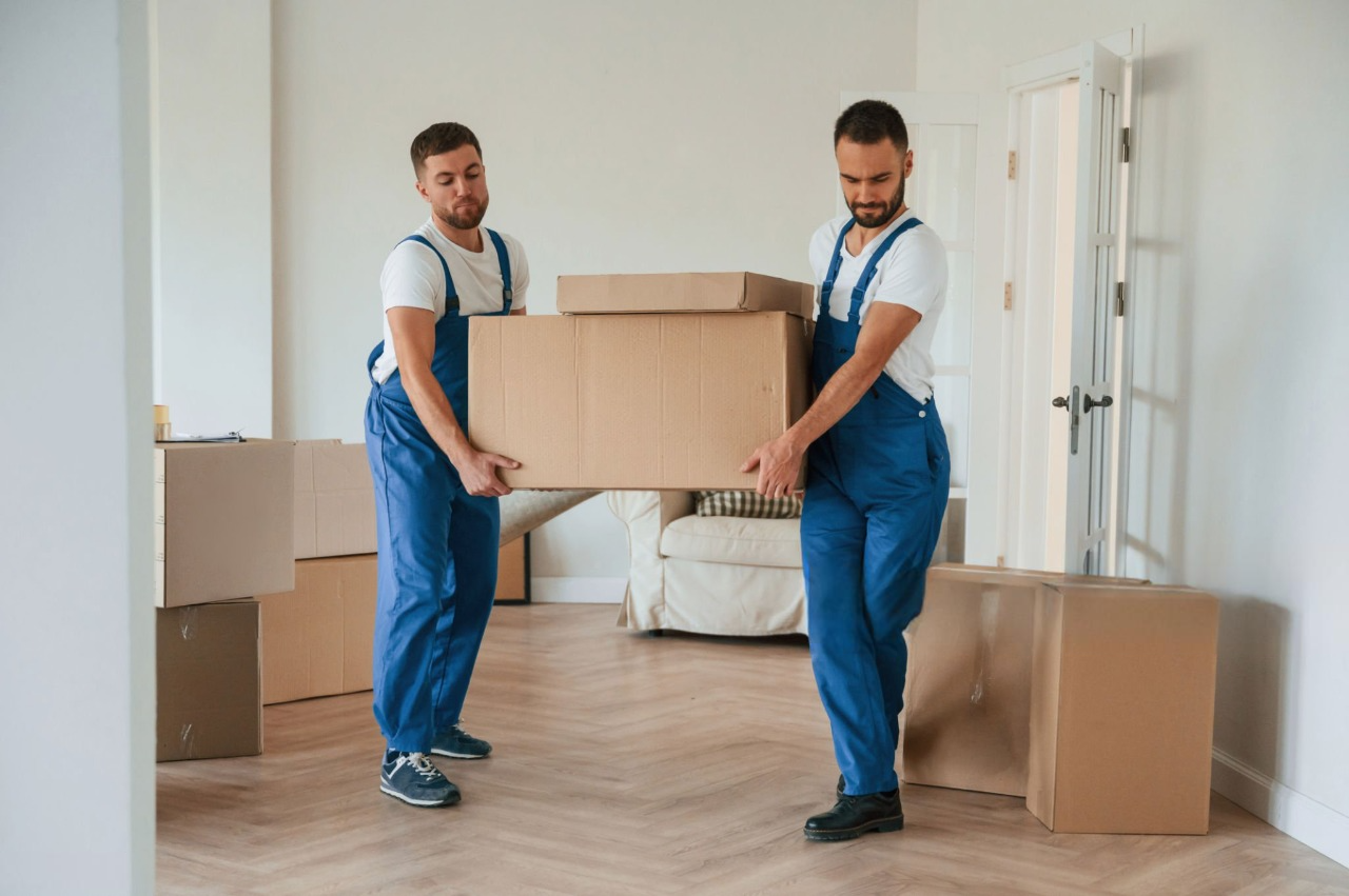 MovePlus team arranging furniture during a relocation