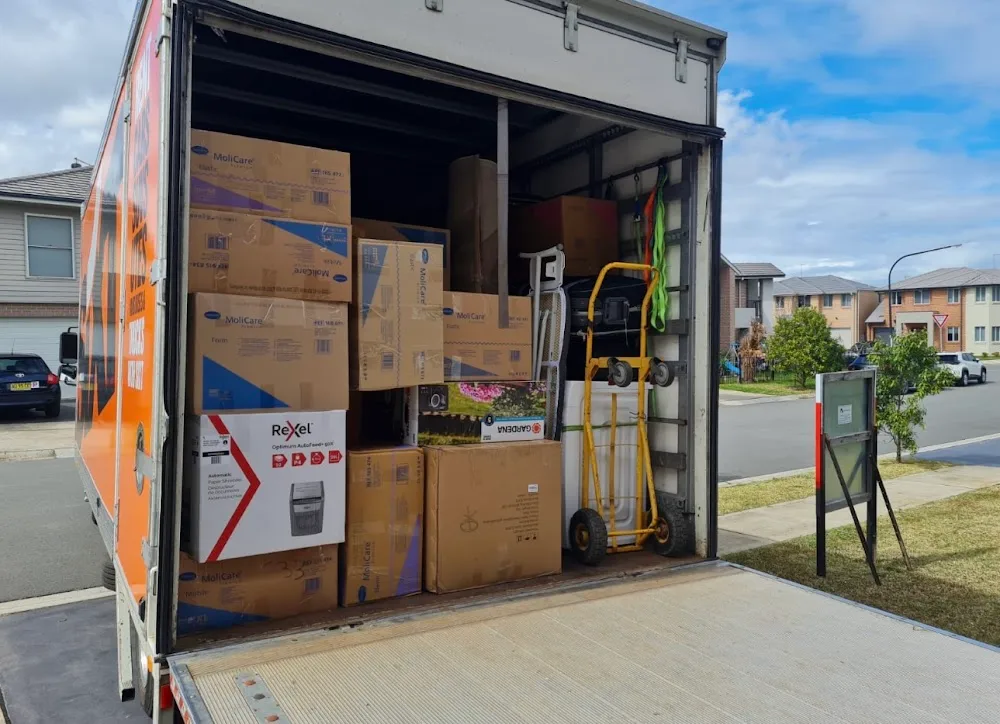 MovePlus team preparing large household items for transport