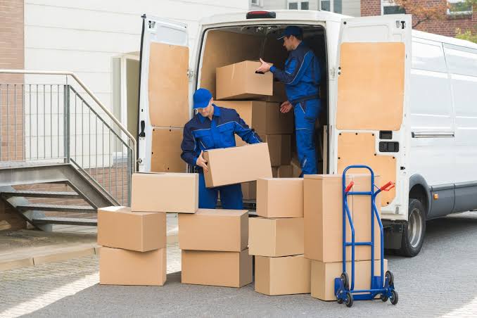 MovePlus movers handling packed boxes during a relocation